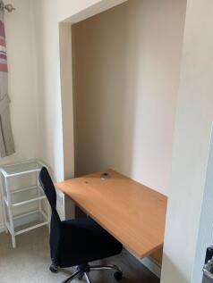 A compact, dedicated workspace featuring a wood...