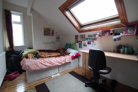 Cozy single bedroom featuring a sloped ceiling ...