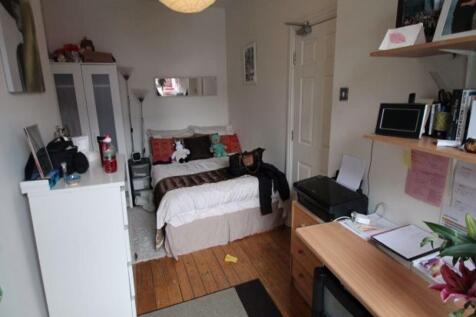 A cozy and well-organized single bedroom featur...