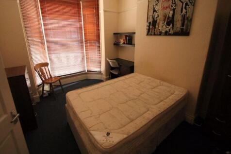 Cozy single bedroom featuring a comfortable bed...