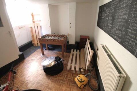 A bright storage room with parquet flooring, fe...