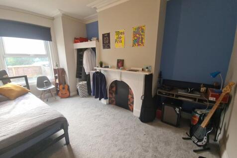 A spacious and inviting master bedroom featurin...