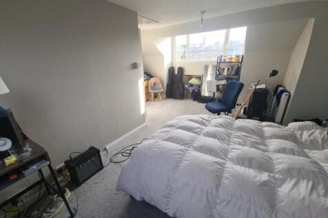 Bright and spacious master bedroom featuring a ...