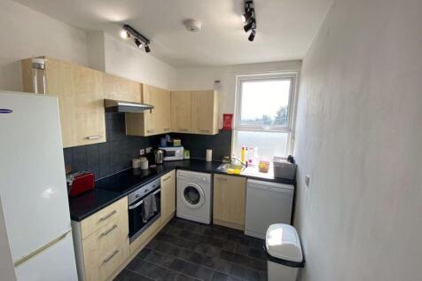 Bright and modern kitchen featuring light wood ...
