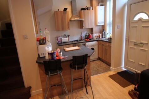 A modern kitchen area featuring a breakfast bar...