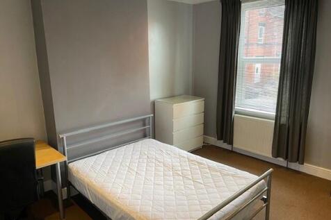 Bright double bedroom featuring a metal frame b...