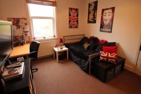 A cozy and well-maintained bedroom featuring a ...
