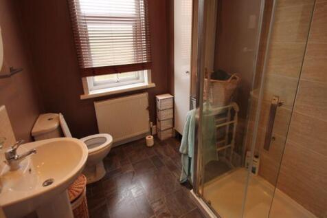 Bright and clean bathroom featuring a modern wa...
