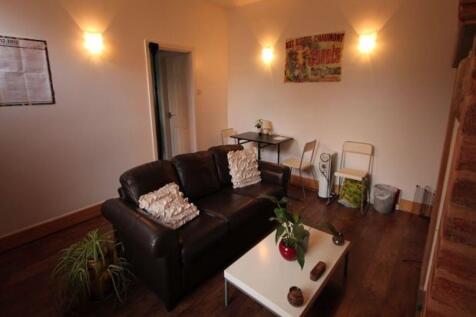 Cozy living room featuring a comfortable leathe...
