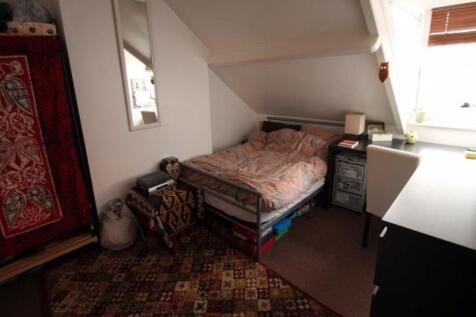 Cozy single bedroom with a skylight window offe...