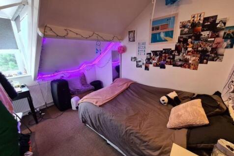 Cozy and personalized bedroom featuring a comfo...