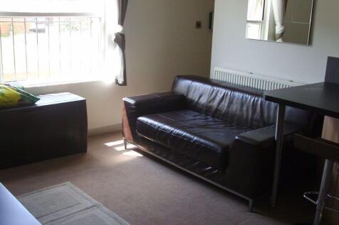 A cozy living room featuring a comfortable leat...