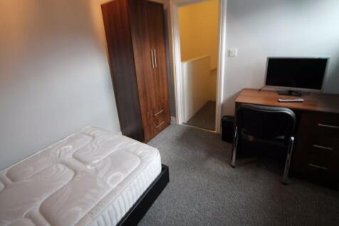 A neat and functional single bedroom featuring ...