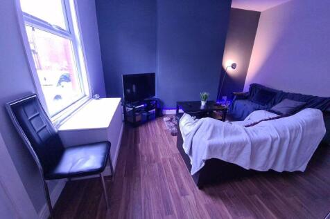 A cozy living room featuring a comfortable sofa...