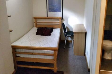 A compact and tidy single bedroom featuring a w...