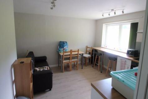 A bright and tidy living room featuring a large...