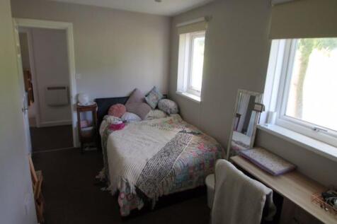 A tidy and well-maintained small bedroom with a...