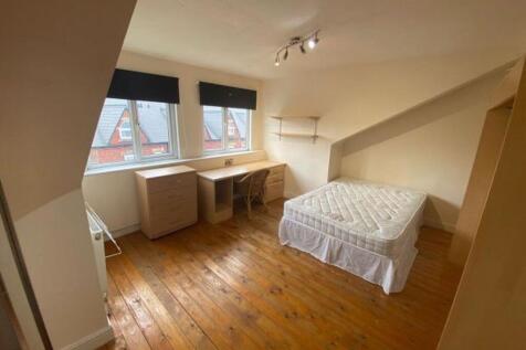 Bright and spacious master bedroom featuring na...