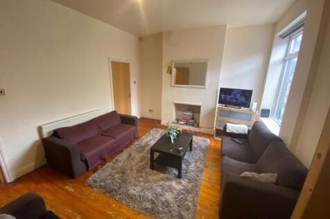 Spacious and inviting living room featuring com...