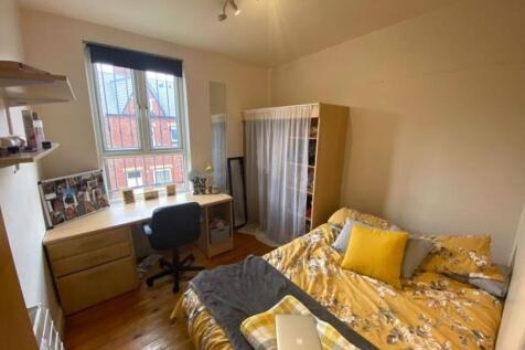 Cozy double bedroom featuring a comfortable bed...