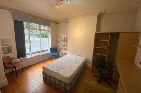 Bright double bedroom featuring a large window ...