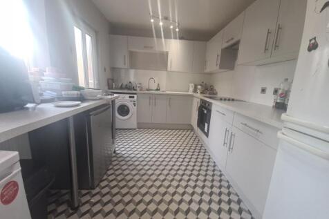 Bright and modern kitchen featuring ample cabin...