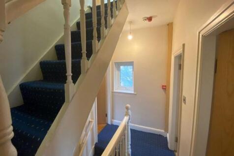 A clean, well-maintained hallway with blue carp...