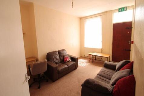 A cozy communal lounge with two comfortable sof...