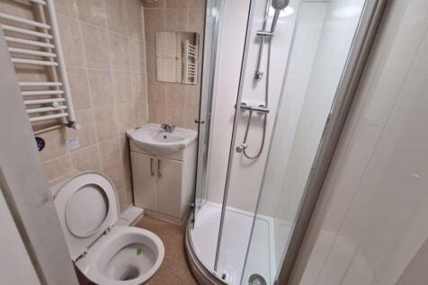 A clean and modern bathroom featuring a curved ...