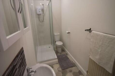 Bright and well-maintained bathroom featuring a...