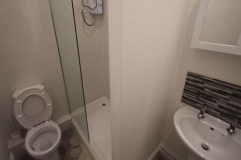 A compact bathroom featuring a toilet, a sink w...