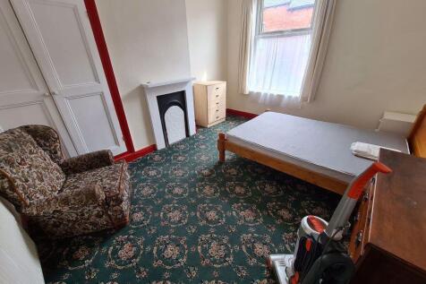 A cozy single bedroom featuring a comfortable a...