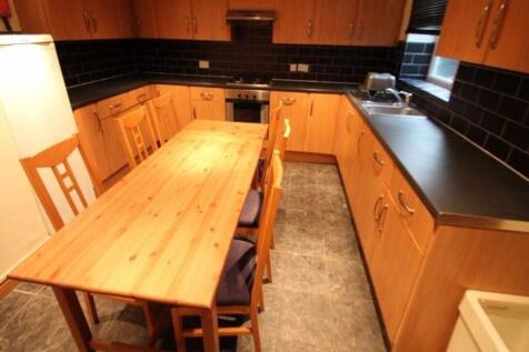 A warm and inviting kitchen featuring wooden ca...