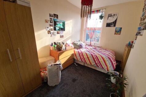 Cozy single bedroom featuring a comfortable bed...