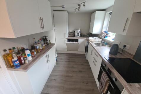 Bright and modern kitchen featuring sleek white...
