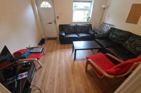 Cozy living room with wooden flooring, a comfor...