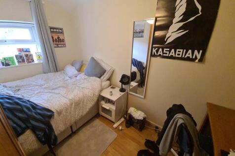 Cozy and compact bedroom featuring a comfortabl...