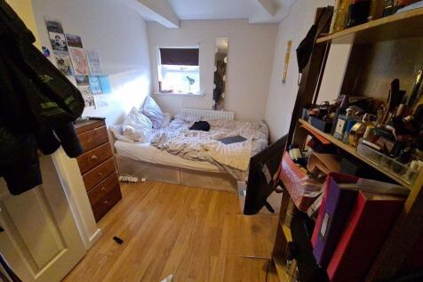 A compact, tidy bathroom featuring a toilet and...