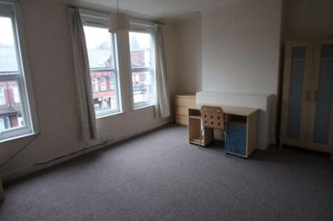 A clean, well-lit room featuring three large wi...