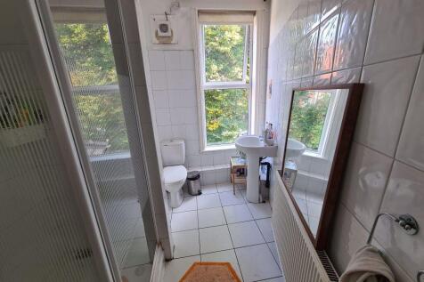 Bright and clean bathroom featuring a large win...