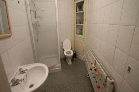 A clean and functional bathroom featuring a wal...