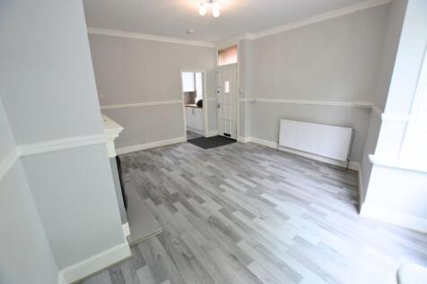 Bright and freshly decorated living room featur...