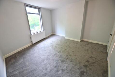 Bright double bedroom featuring a large window ...