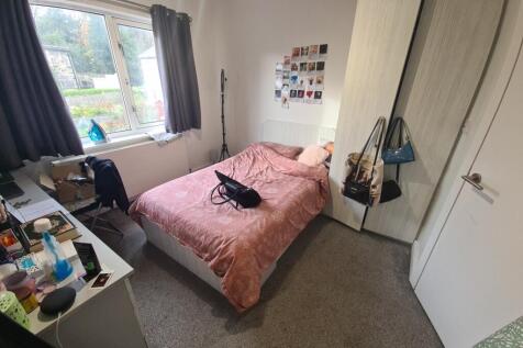 A cozy double bedroom featuring a large window ...
