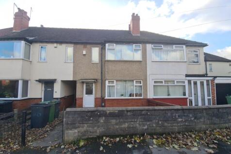 A charming terraced house with a neat front gar...