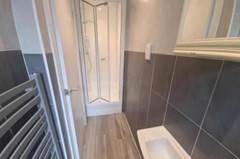 A modern bathroom featuring a sleek shower cubi...