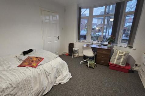 A bright and welcoming master bedroom featuring...