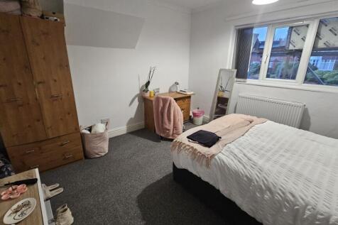A cozy and neatly arranged double bedroom featu...