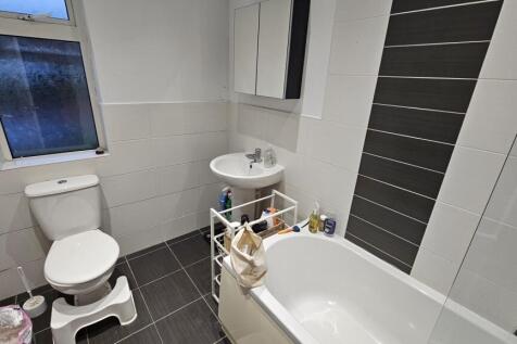 Bright and modern bathroom featuring a full bat...