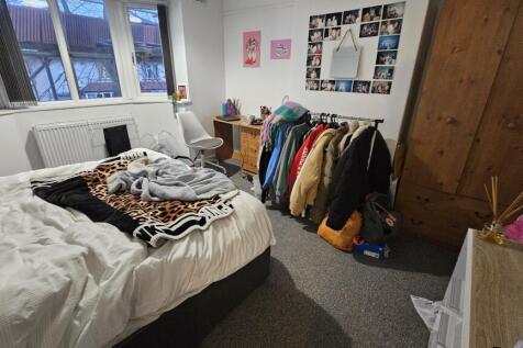 A cozy double bedroom with a comfortable bed, a...